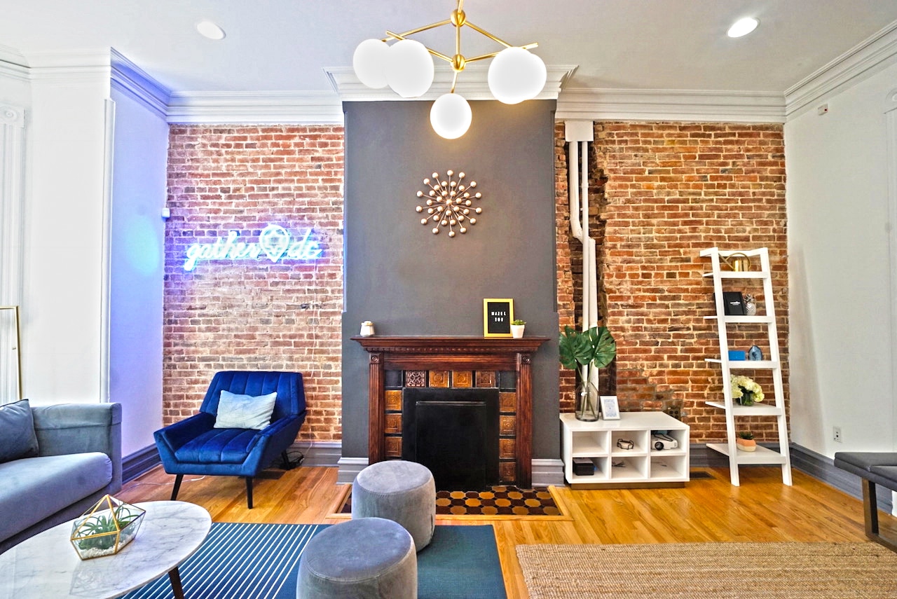 The townhouse living room and neon GatherDC sign. 