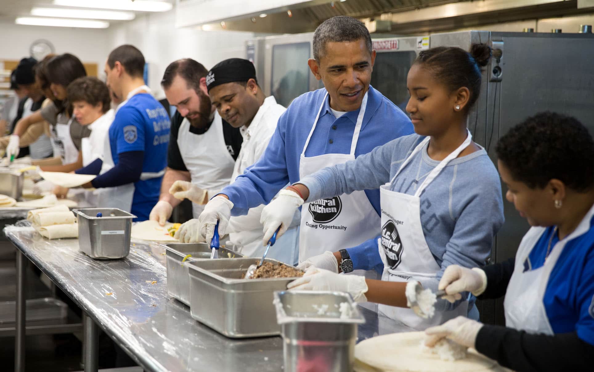 President Barack Obama talks with daughter Sasha, as they along with First Lady Michelle Obama, and daughter Malia prepare burritos while volunteering at the DC Central Kitchen in Washington, D.C., on Martin Luther King Day, Jan. 20, 2014. (Official White House Photo by Pete Souza)