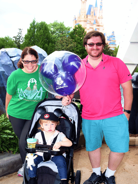 A picture of josh, his wife and daughter at Disneyland