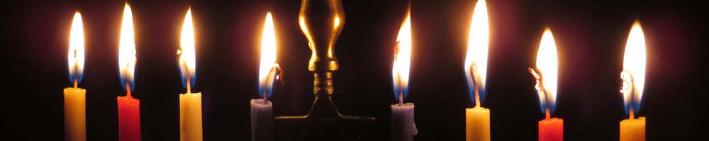 A close up of a fully lit menorah. 