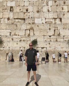 The author stands in front of the Western Wall. 