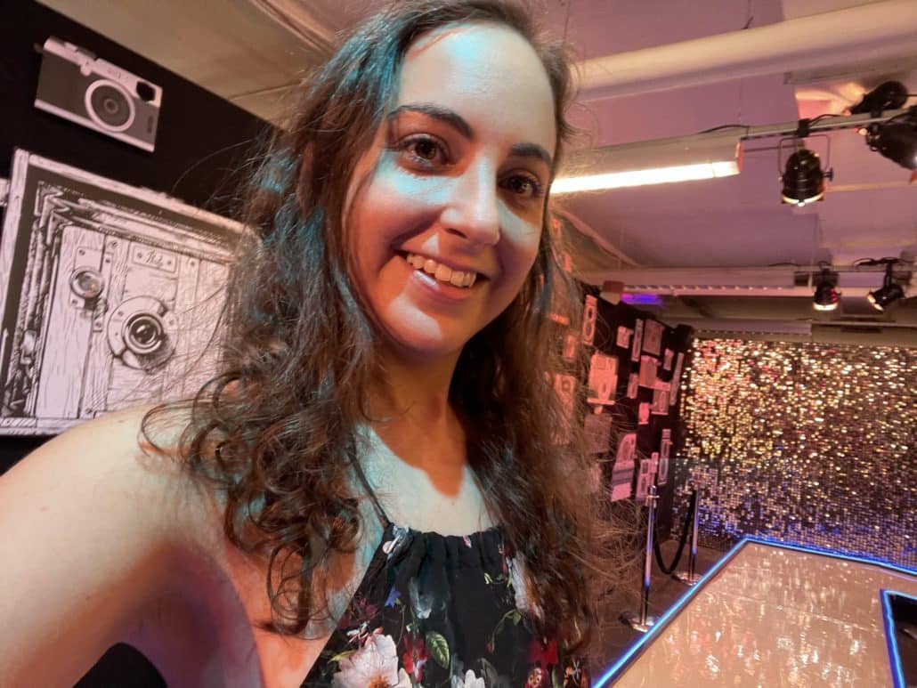 Ilana takes a selfie in a camera-filled art exhibit. 