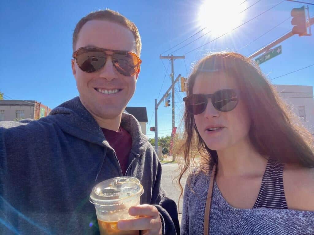 Corey and Rachel sip iced drinks and take a selfie. 