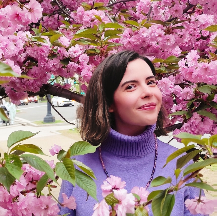 Csendi poses amongst cherry blossoms.