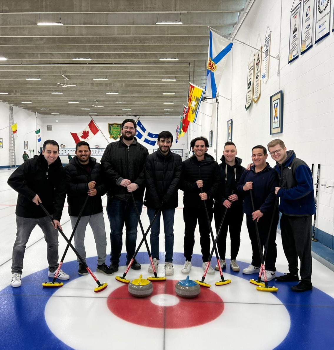 AJ with a group of people curling. 
