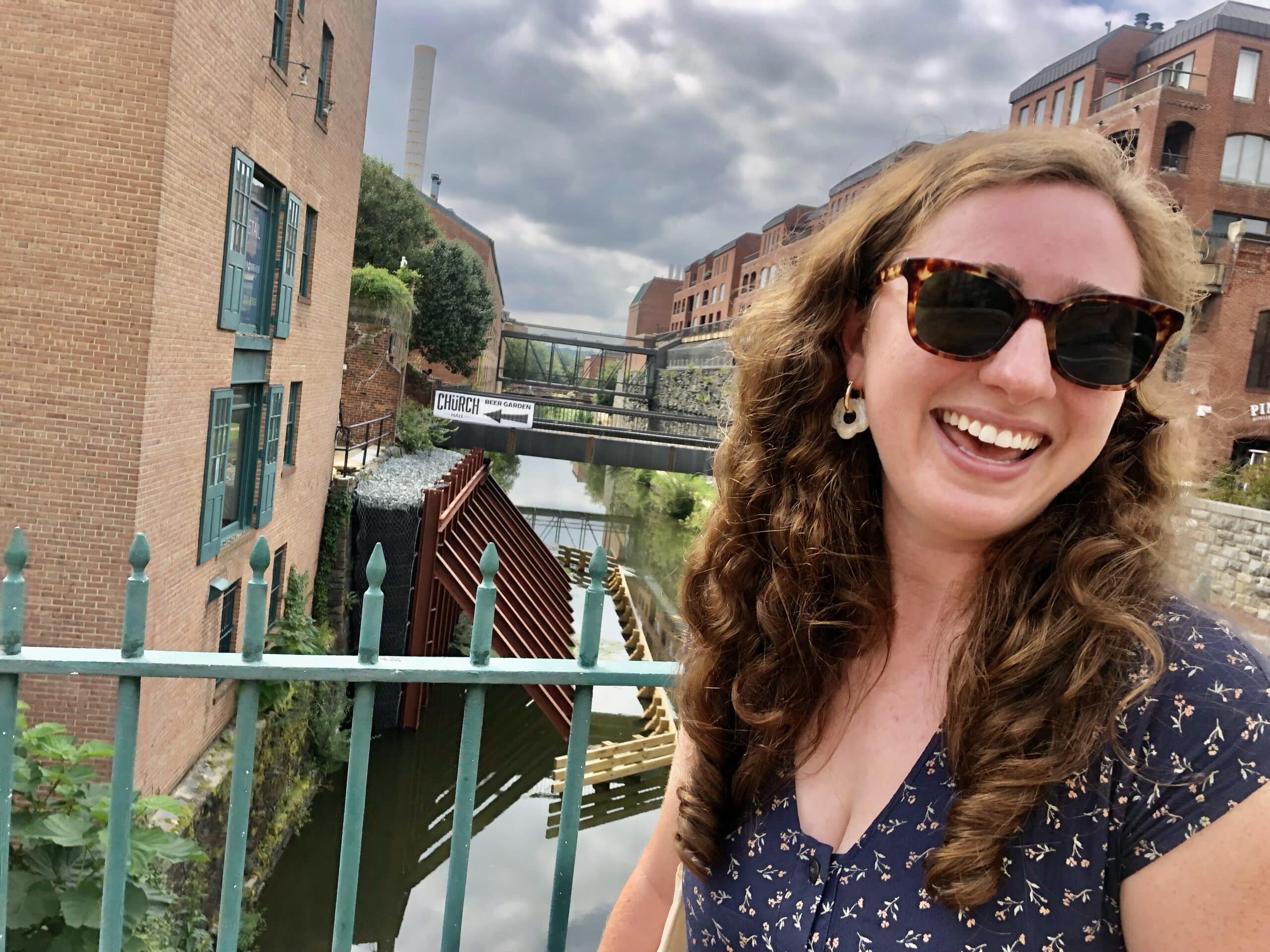 Rachel takes a selfie on a bridge over a canal. 