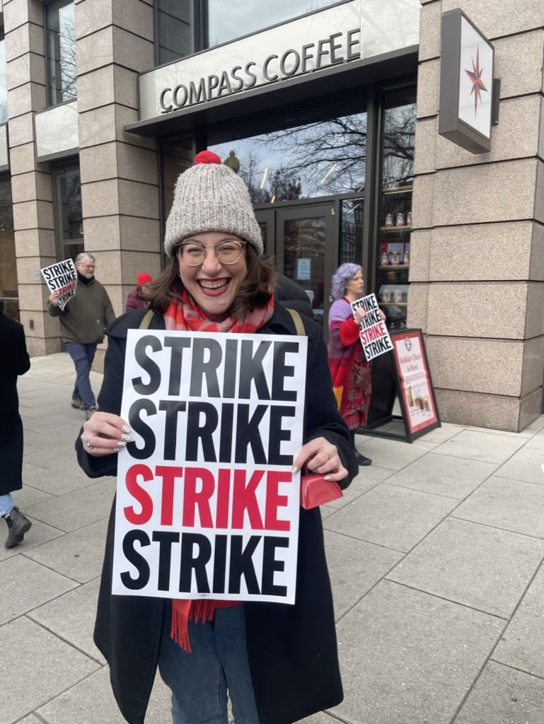 Jackie holding a sign that says STRIKE STRIKE STRIKE STRIKE at the Washington Post Guild walkout. 