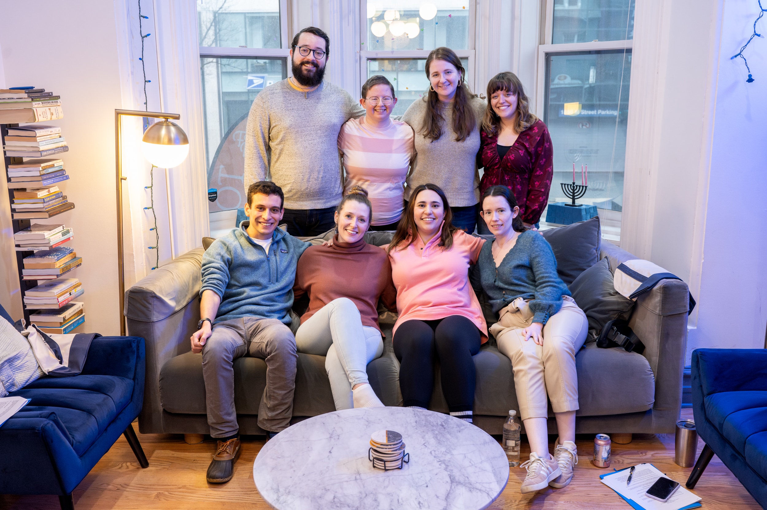 The Open Doors Fellows sit together on a couch in Gather's townhouse.