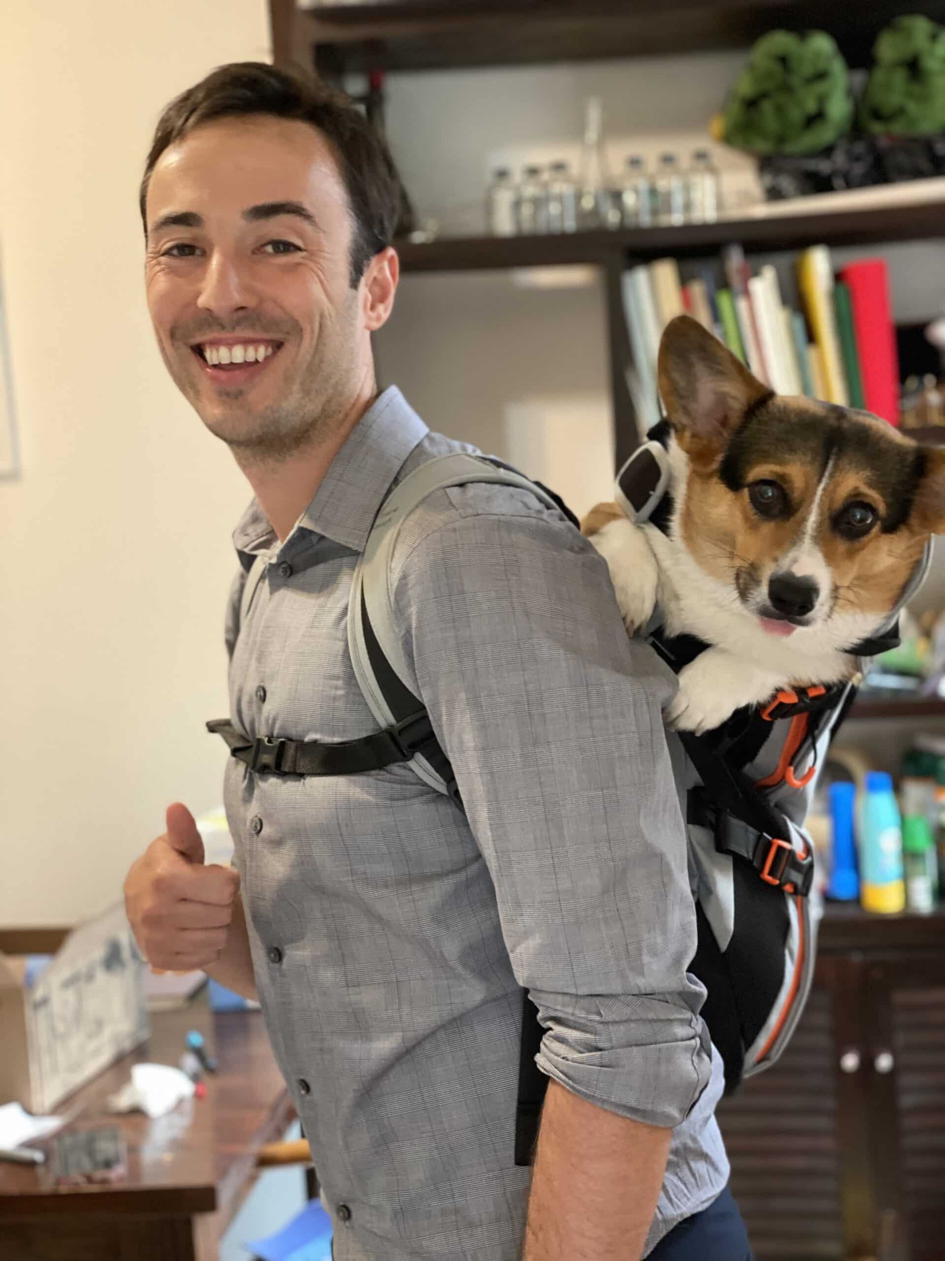 Dillon with his dog in a backpack.