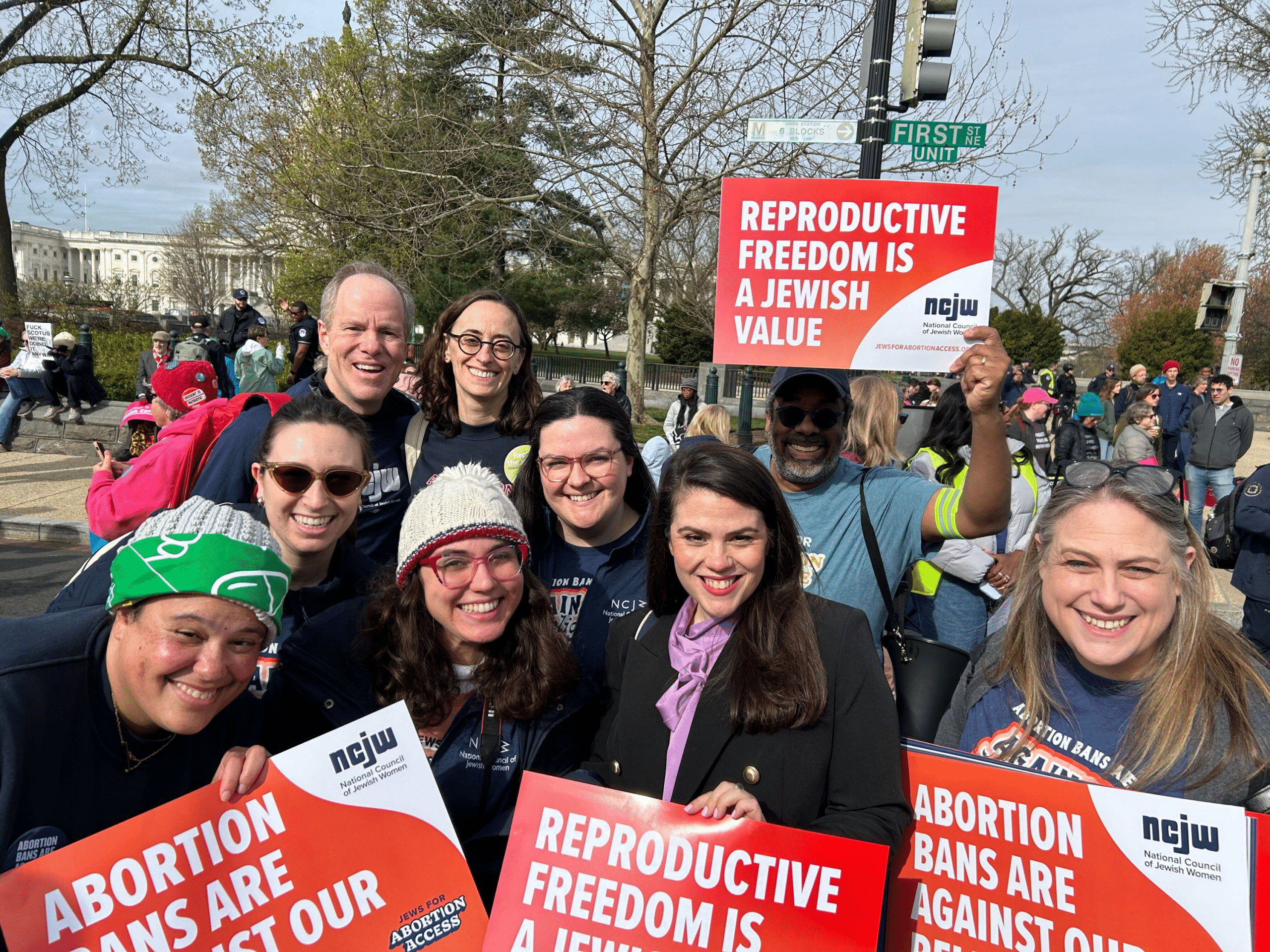 Sarah and others at a protest holding signs that read "Reproductive Freedom is a Jewish Value"