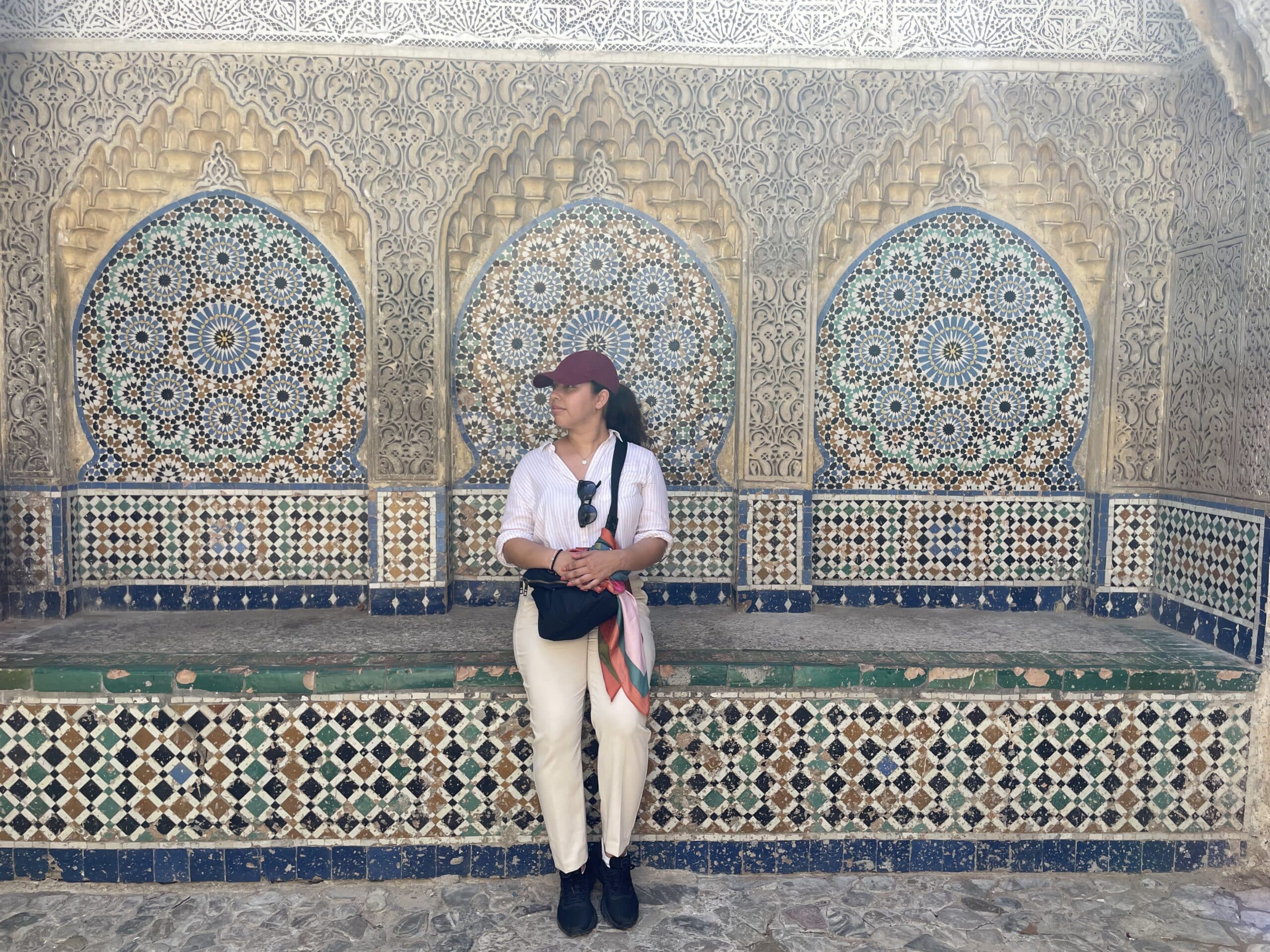 Stacy in front of an intricate mosaic.