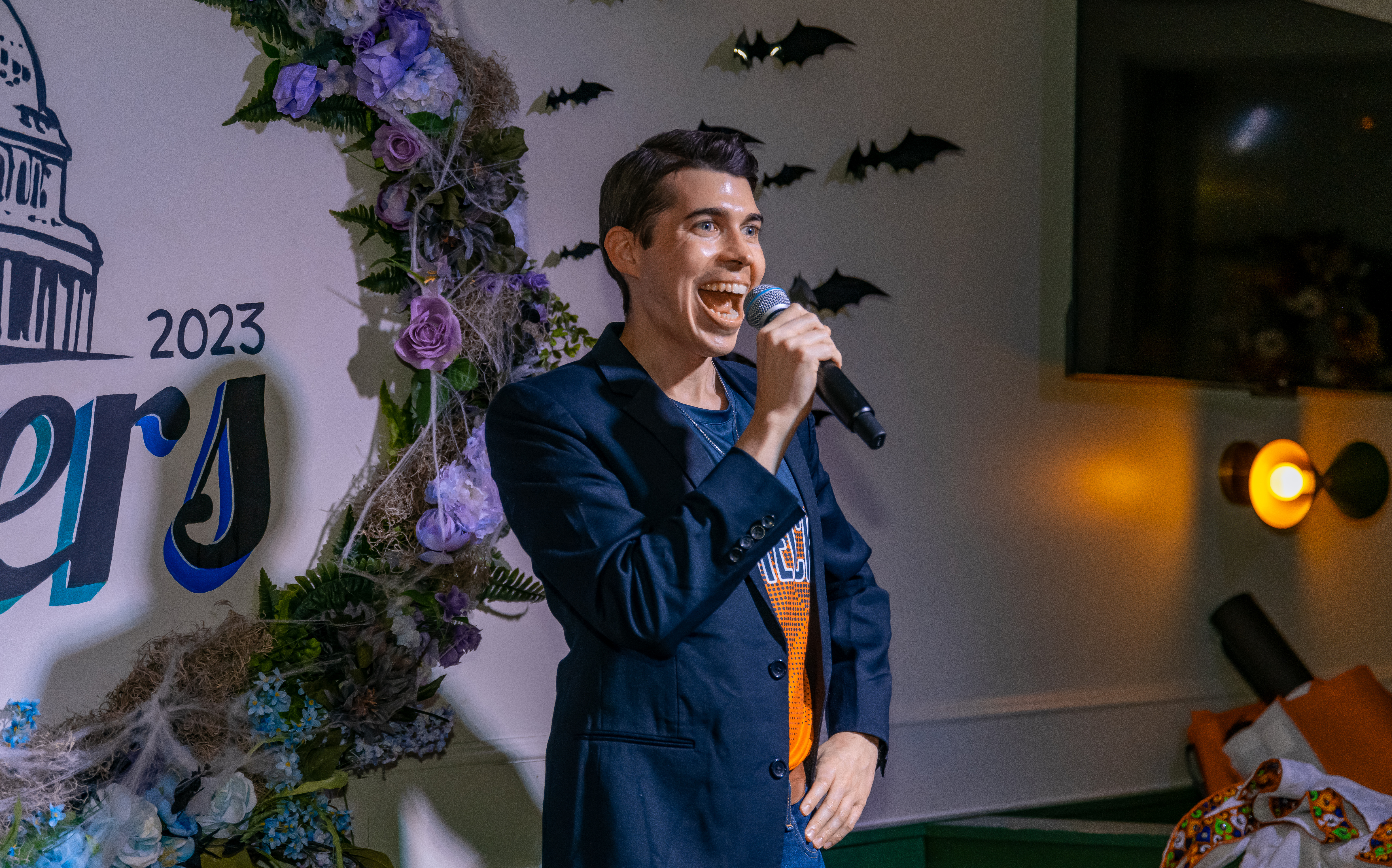 Alejandro onstage at Stonewall's Got Talent, performing standup comedy. 