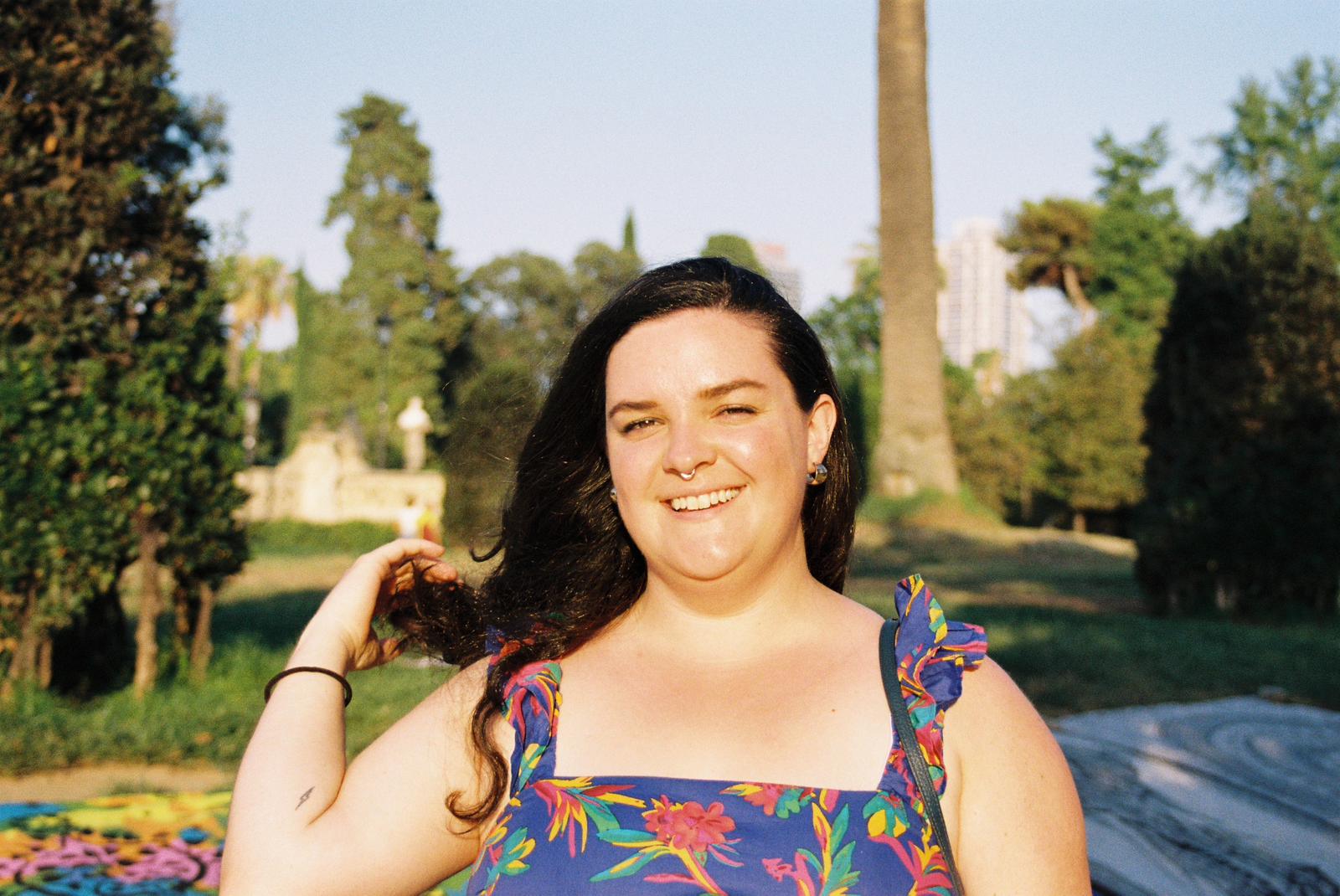 A film photo of Sarah in a blue floral dress.