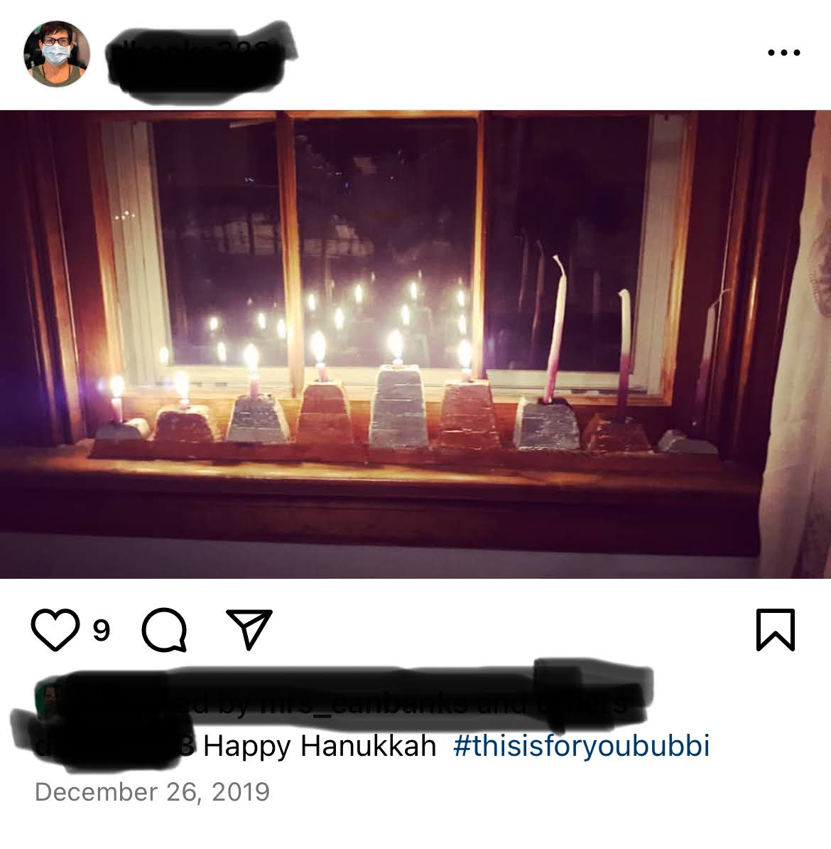 An Instagram post of a menorah in a window.