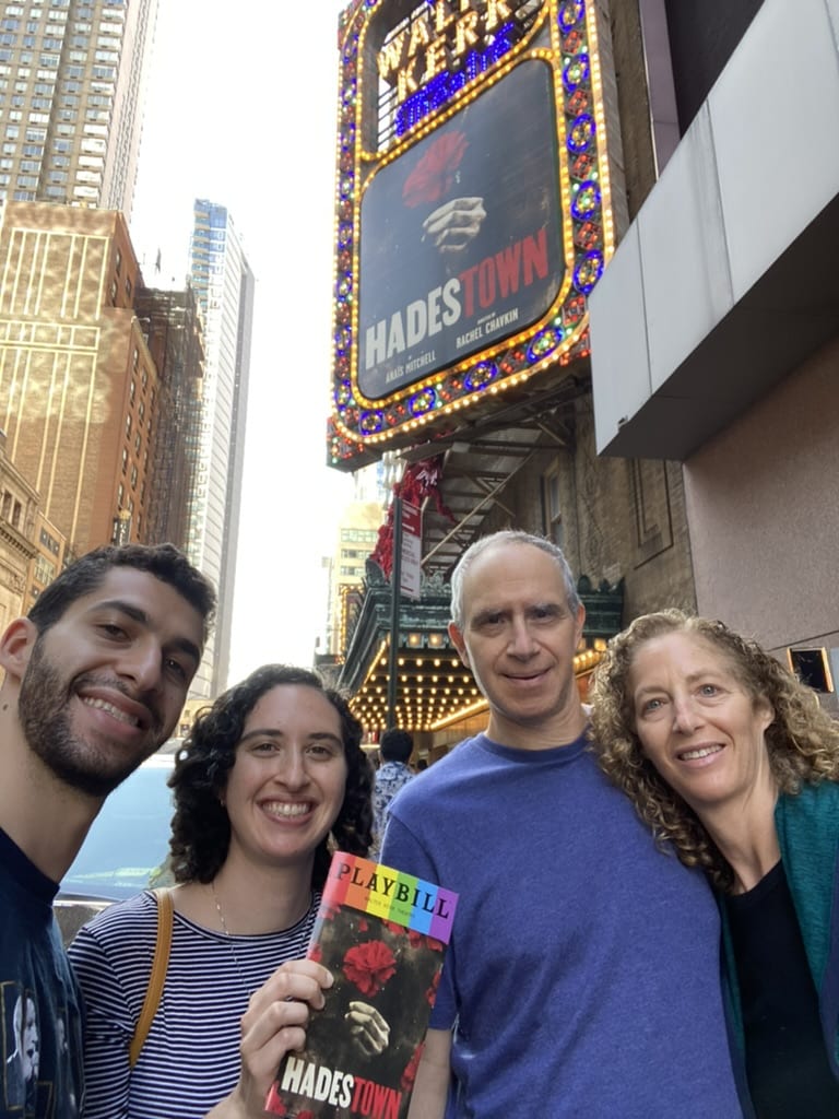 Ronit and family on Broadway in front of a Hadestown bill.