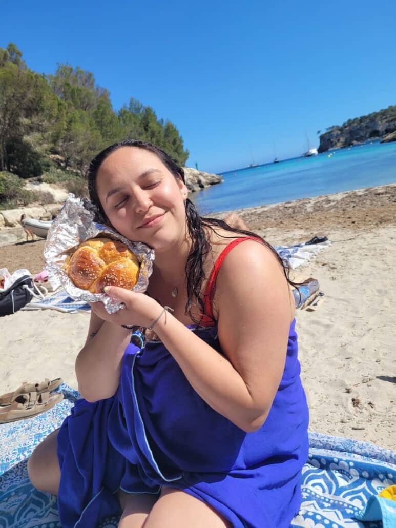 Heather at the beach with challah wrapped in tin foil.