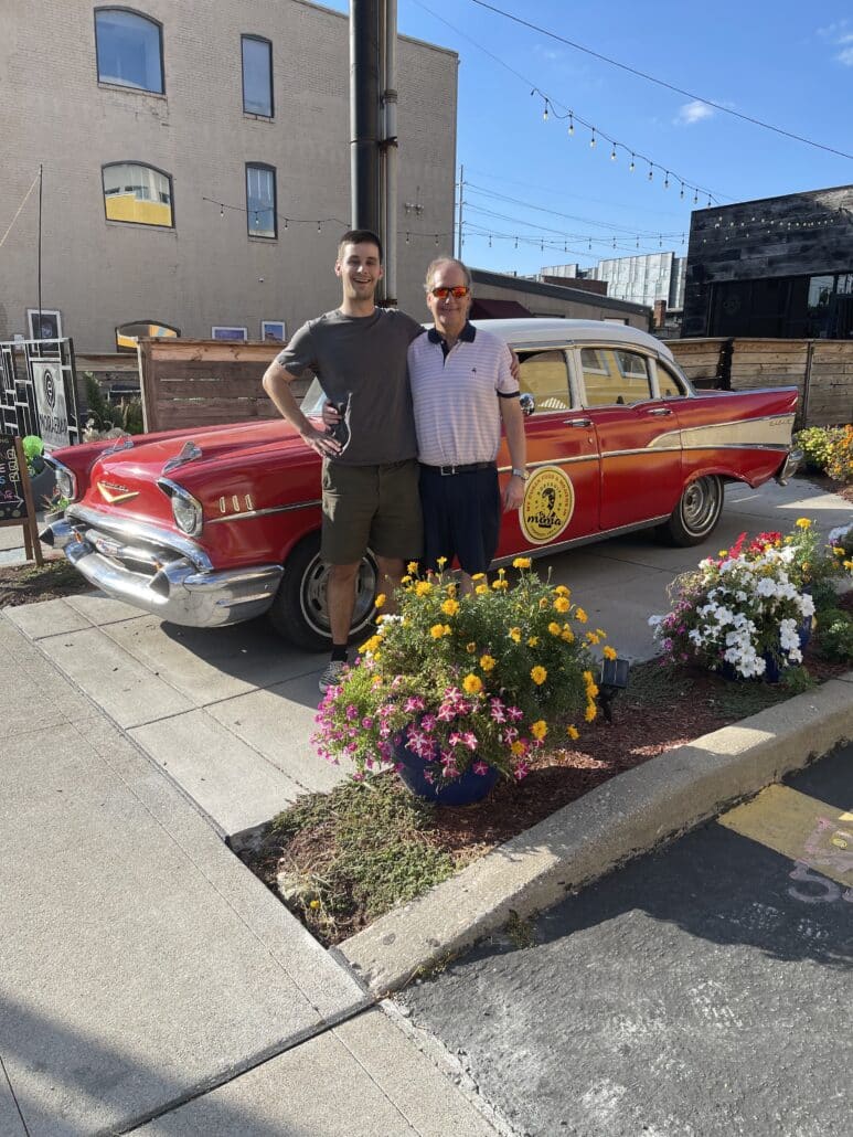 Ethan, another person, and a classic car.