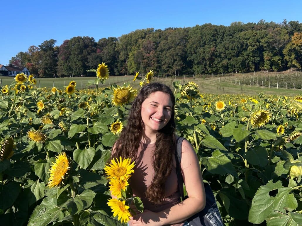 Jenna in a field of sunflowers.