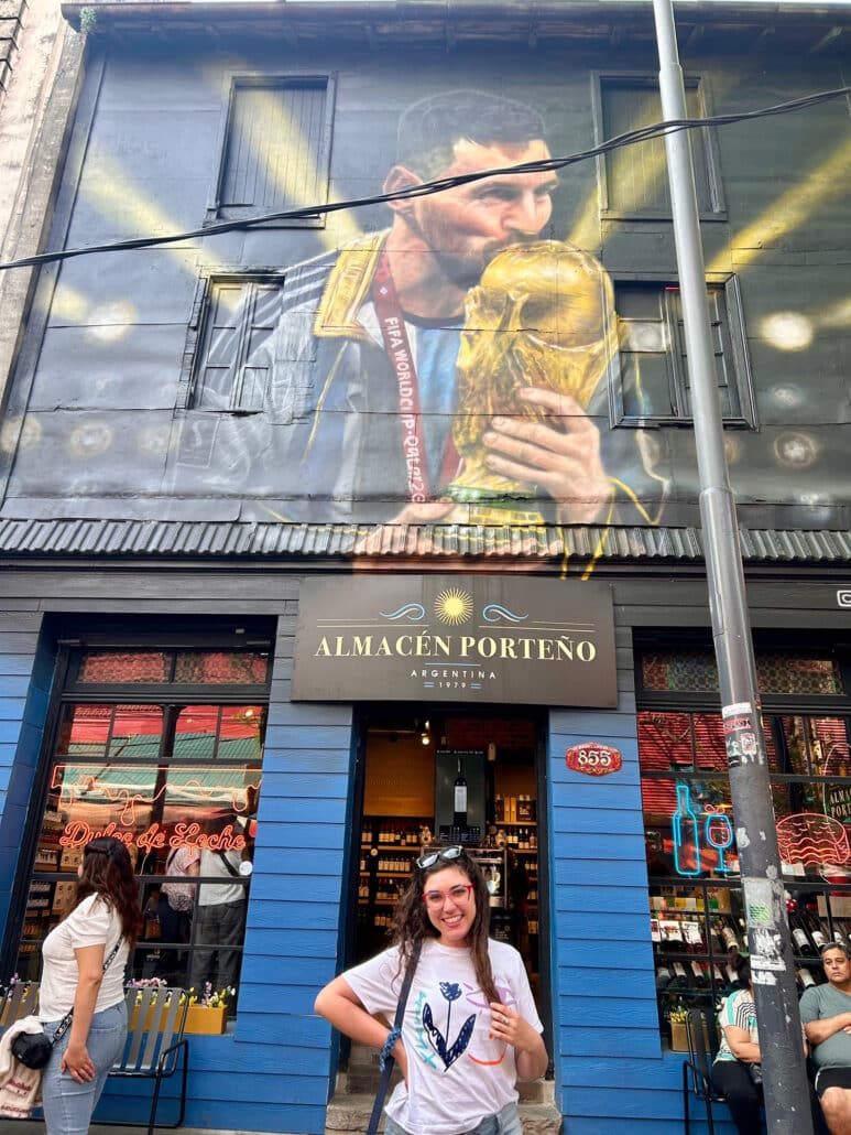 Anahi in front of a Lionel Messi mural.