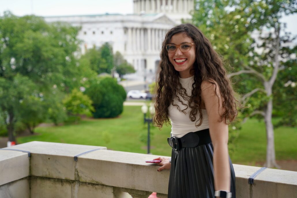 Anahi on a balcony near the US Capitol.