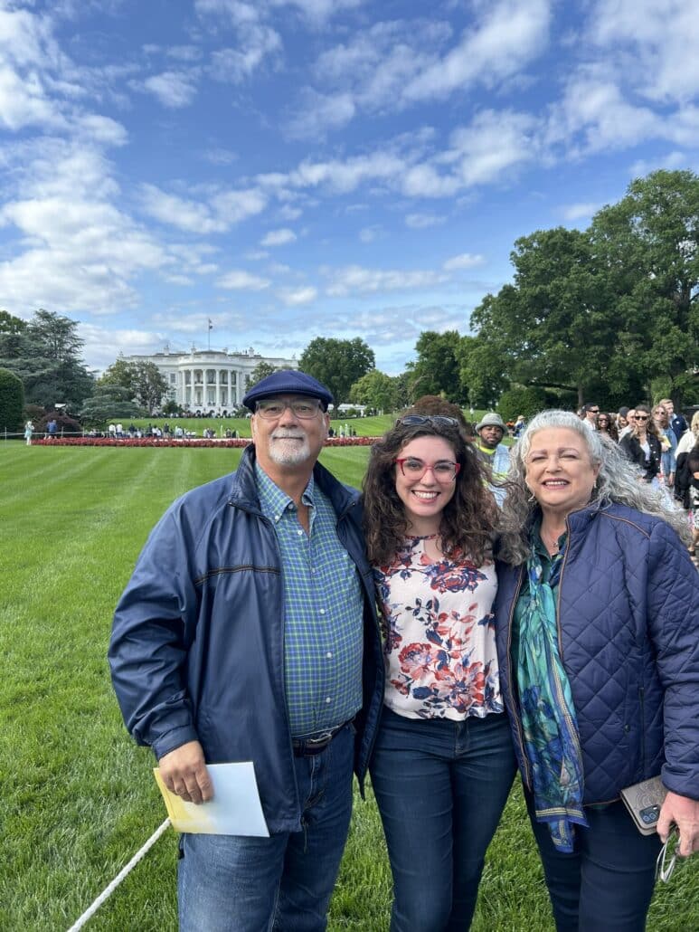 Anahi and her parents on the lawn in front of the White House.