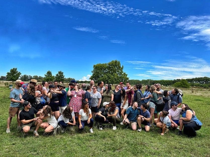 Naomi in a group photo outside with a HMI cohort.