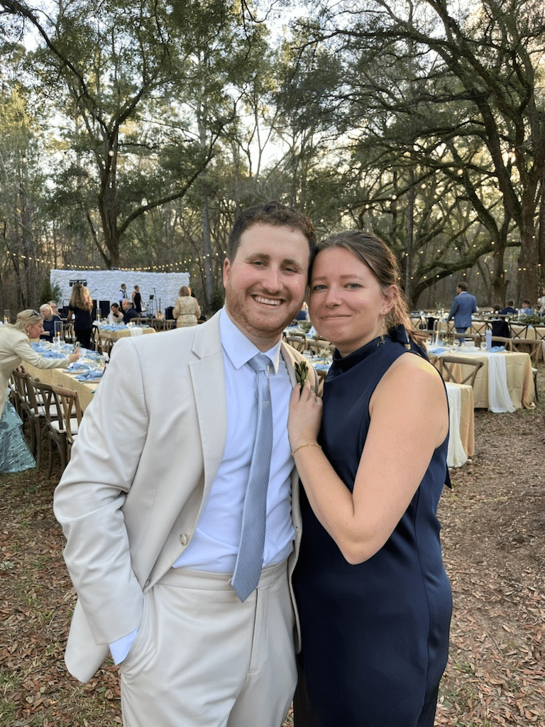 Adam in a tan suit at a wedding.
