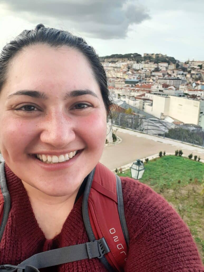 A selfie of Emma above a city center.