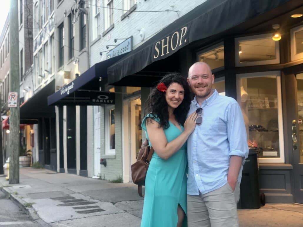 Richard and his fiance, Dani, in front of storefronts.
