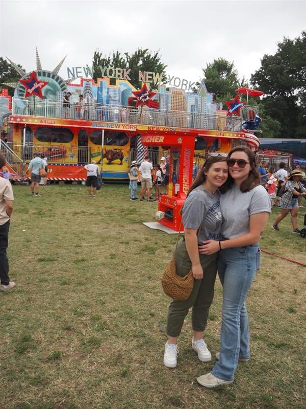 Hally and her girlfriend at a carnival.