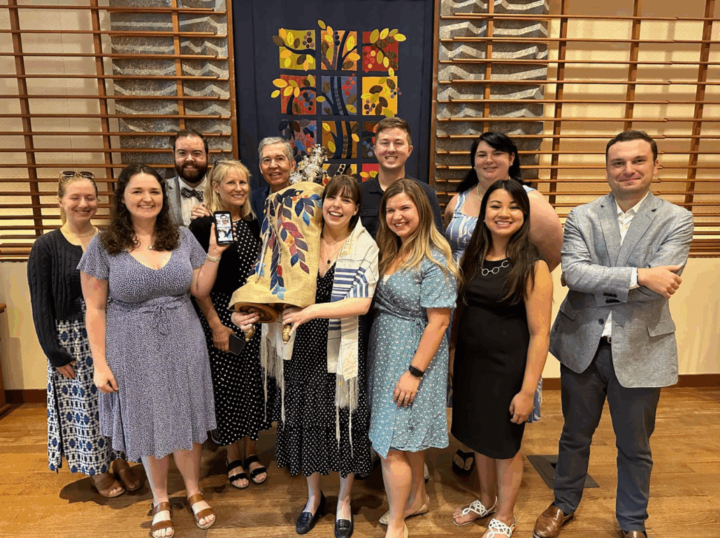 Claire, family, and friends with the Torah.