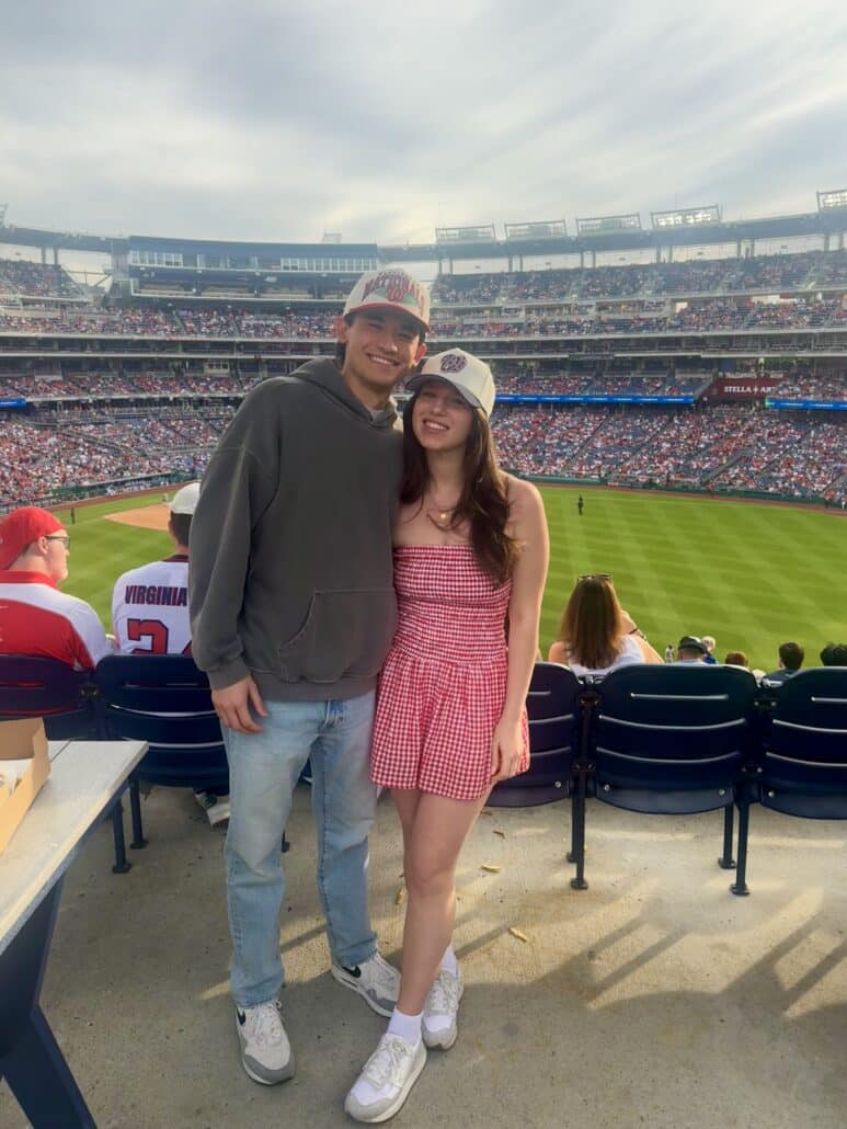 Hannah and a man at a baseball game.