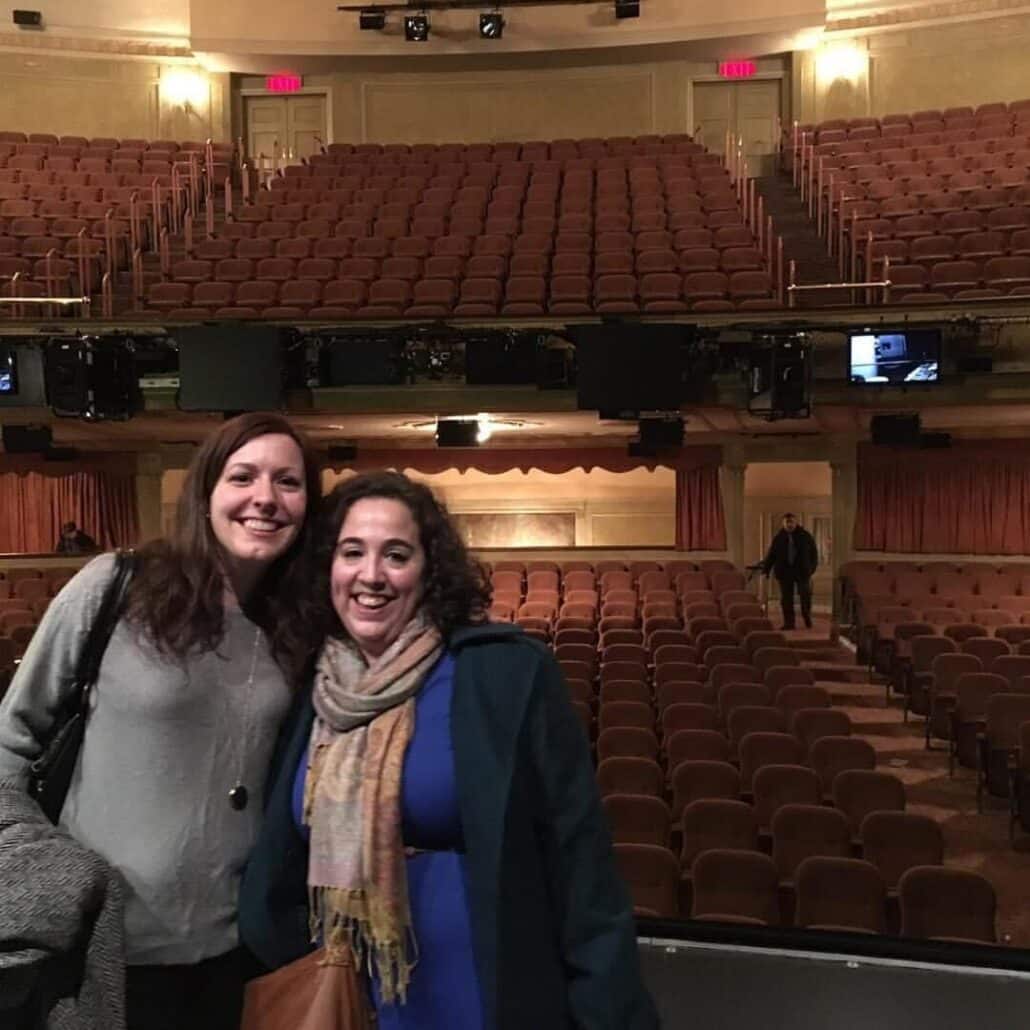 Rachel and a friend at a theater.