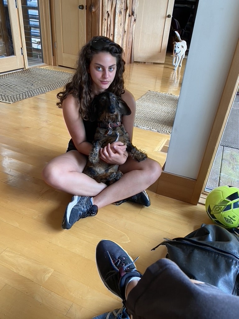Hannah holding a dog.