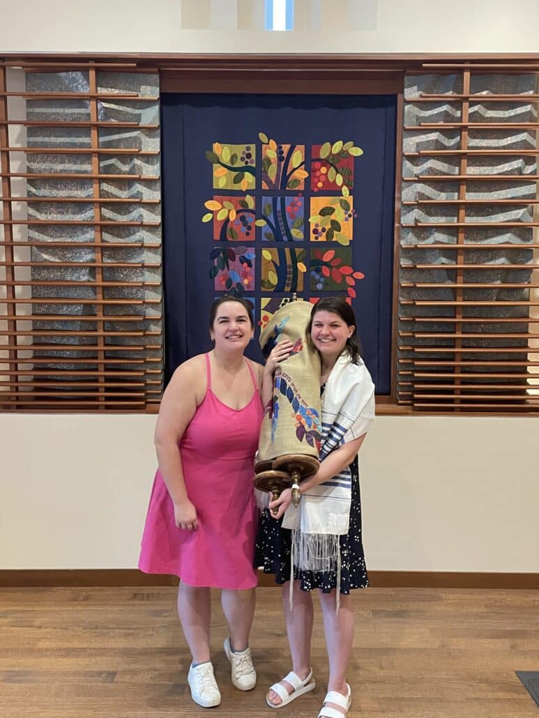 Sara with a friend and Torah.
