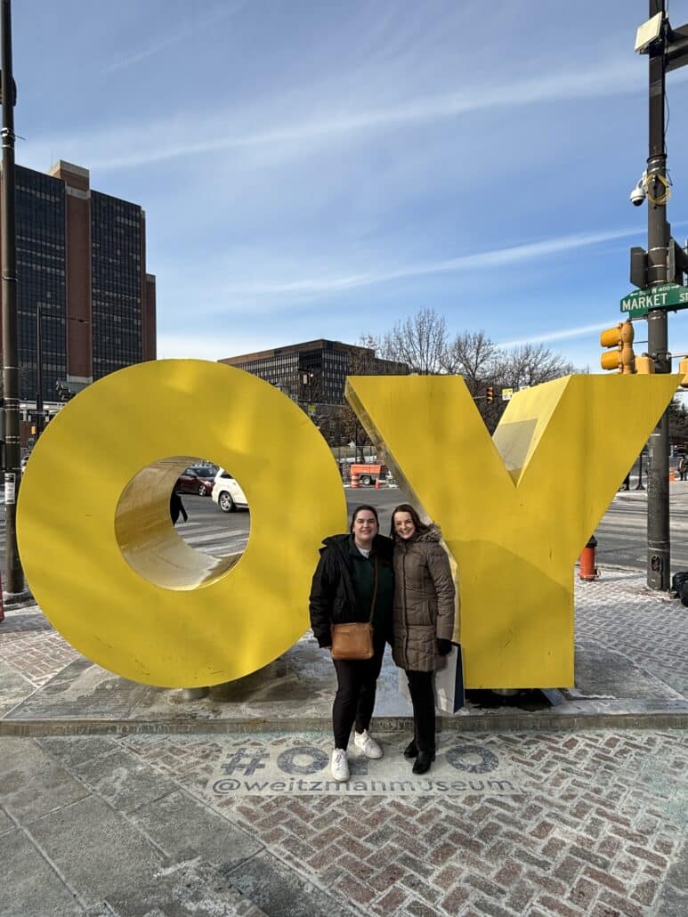 Sara and a friend with an outdoor OY sculpture.