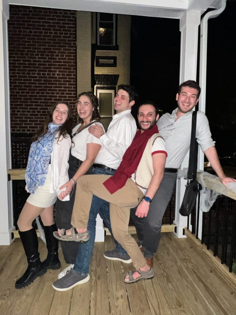 Mitchell and friends pose on a porch.