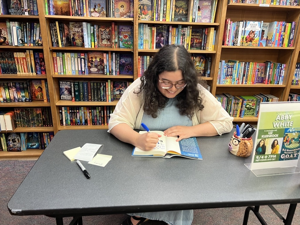Abby signing books.