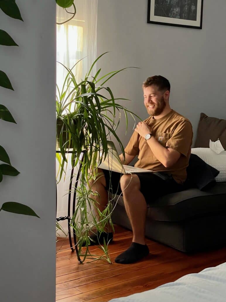 David in a living room with plants.
