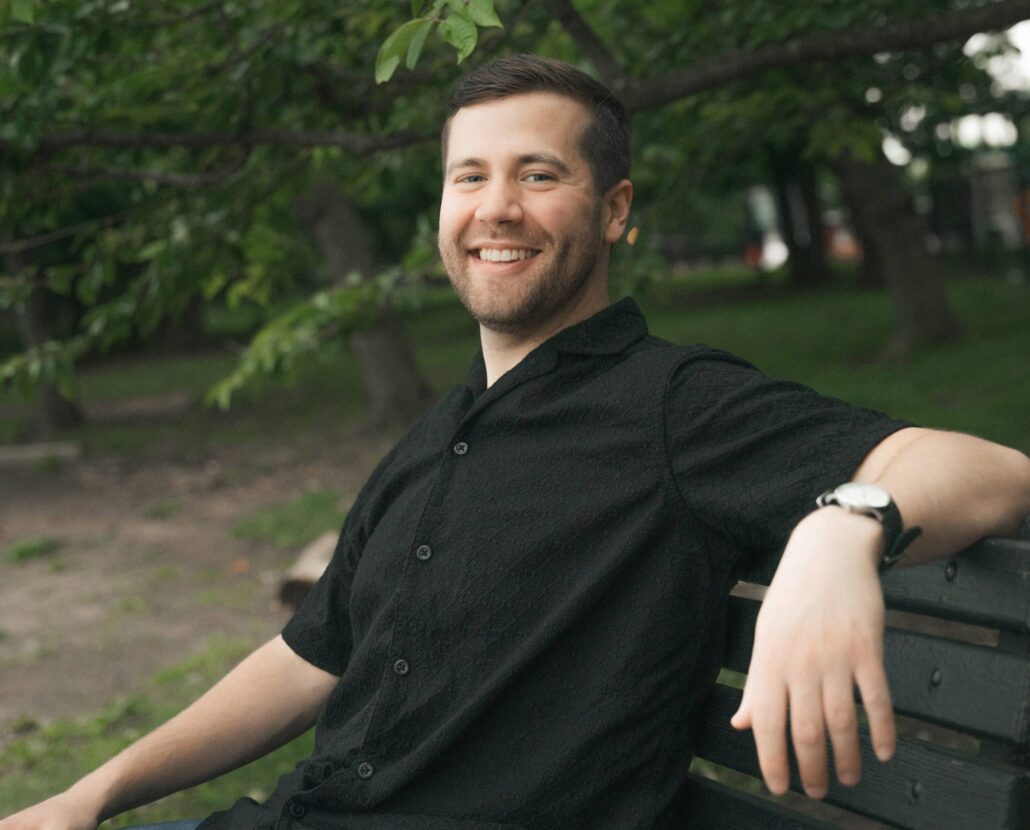 David in a black shirt on a bench.