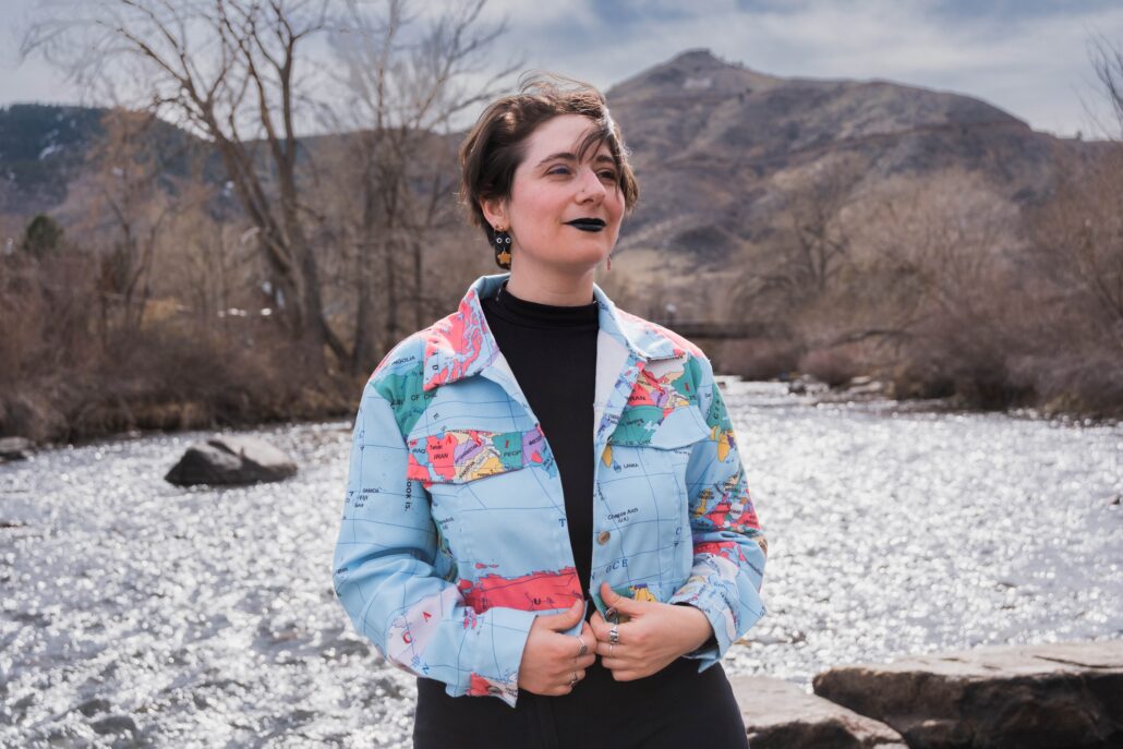 Avrah outdoors in a globe jacket.