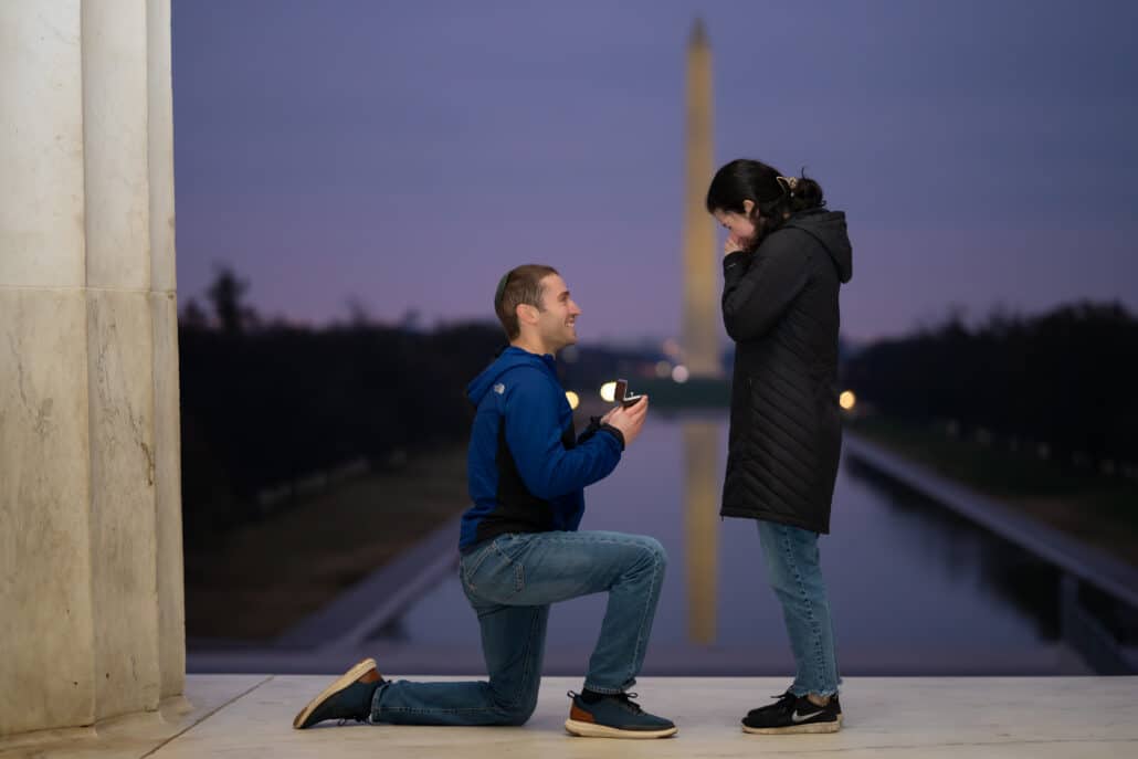 Zach on one knee at the Lincoln Memorial. Maya with her head in her hands.