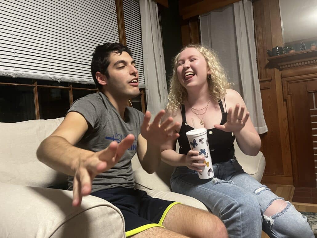 Jake and a friend dancing, seated.