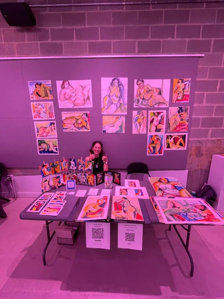 Tamar with a table full of her grandmother's paintings.