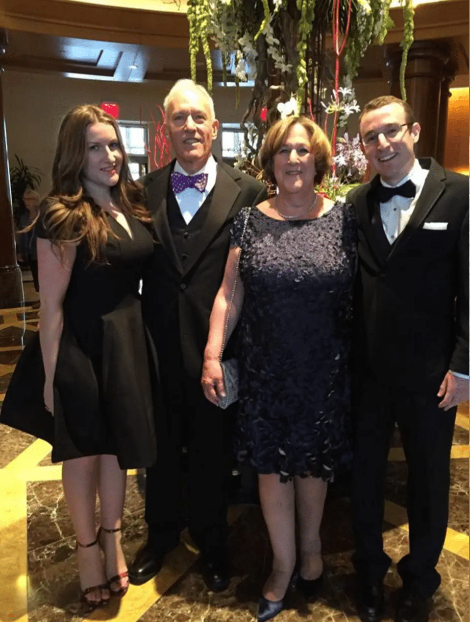 Lauren and family in black tie dress.