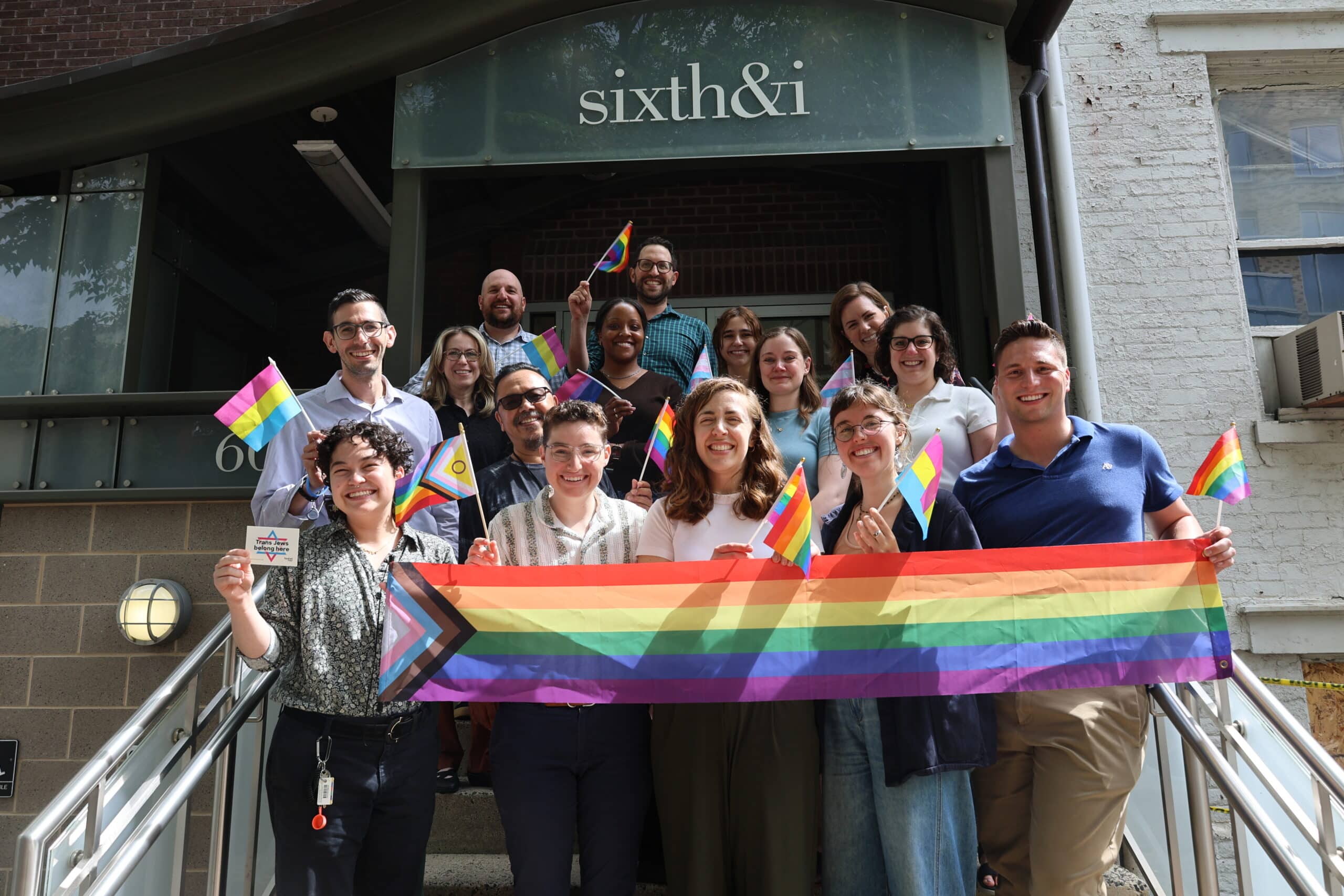 Sixth & I staff holding Pride flags.