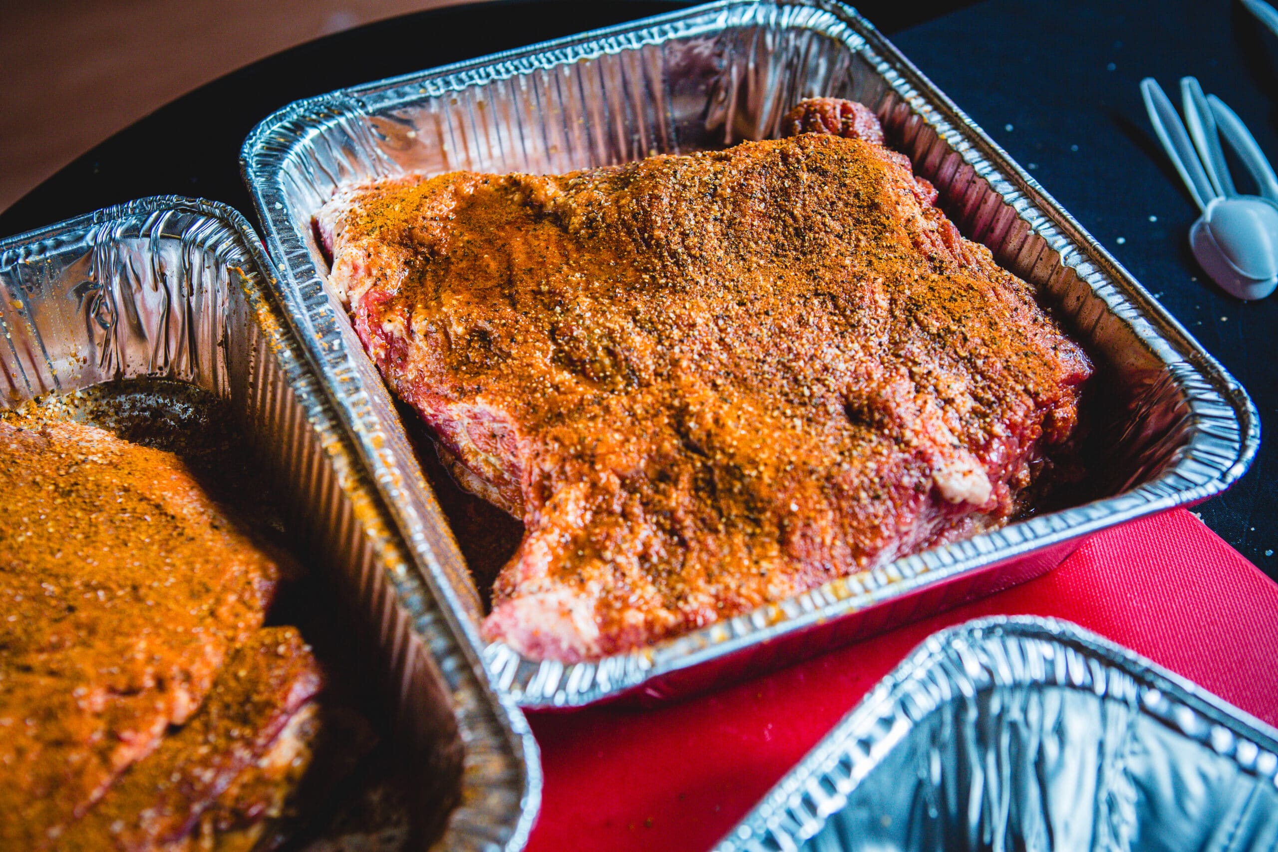 Meat with a dry rub in a serving container. 