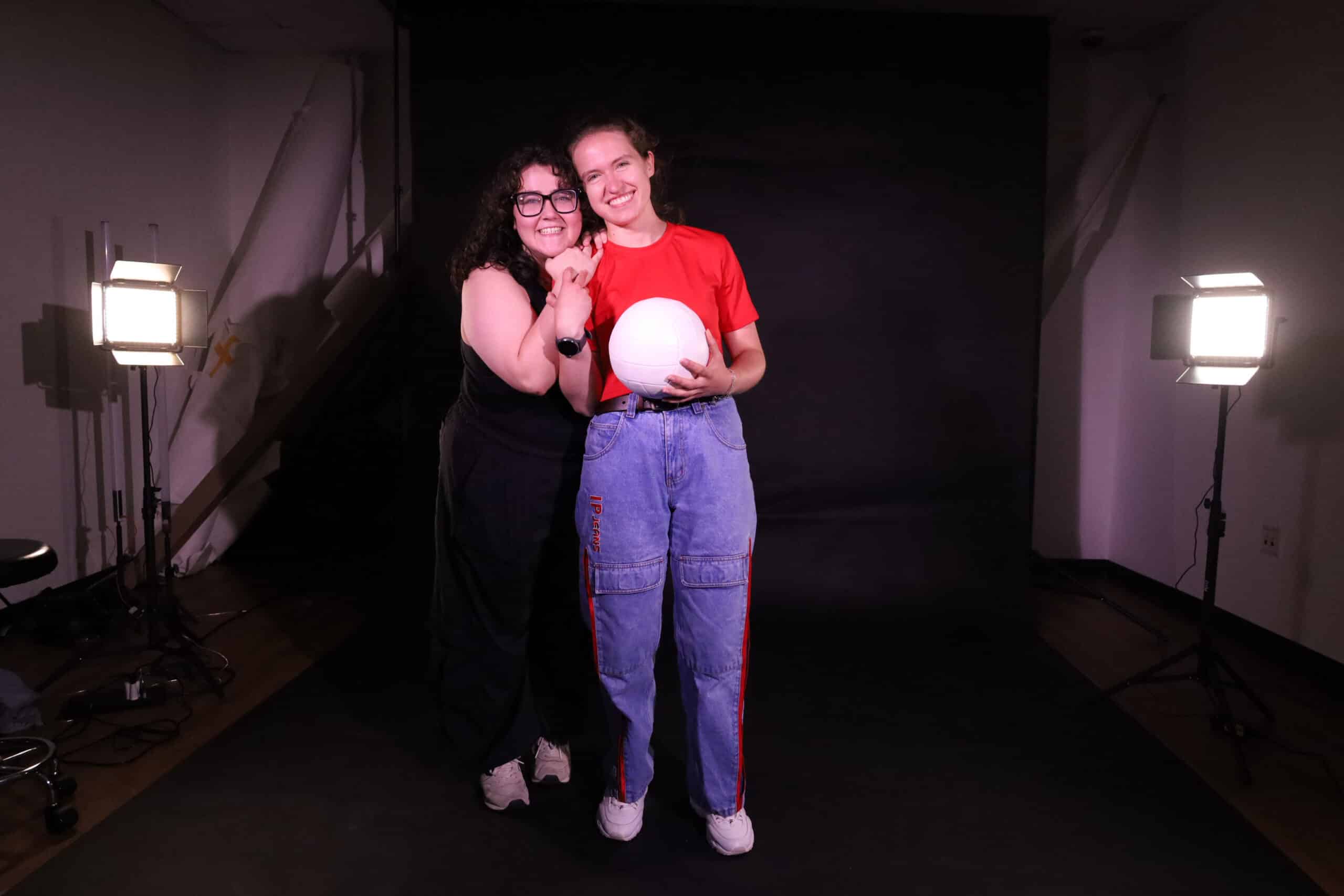 Aimee onstage with a volleyball.