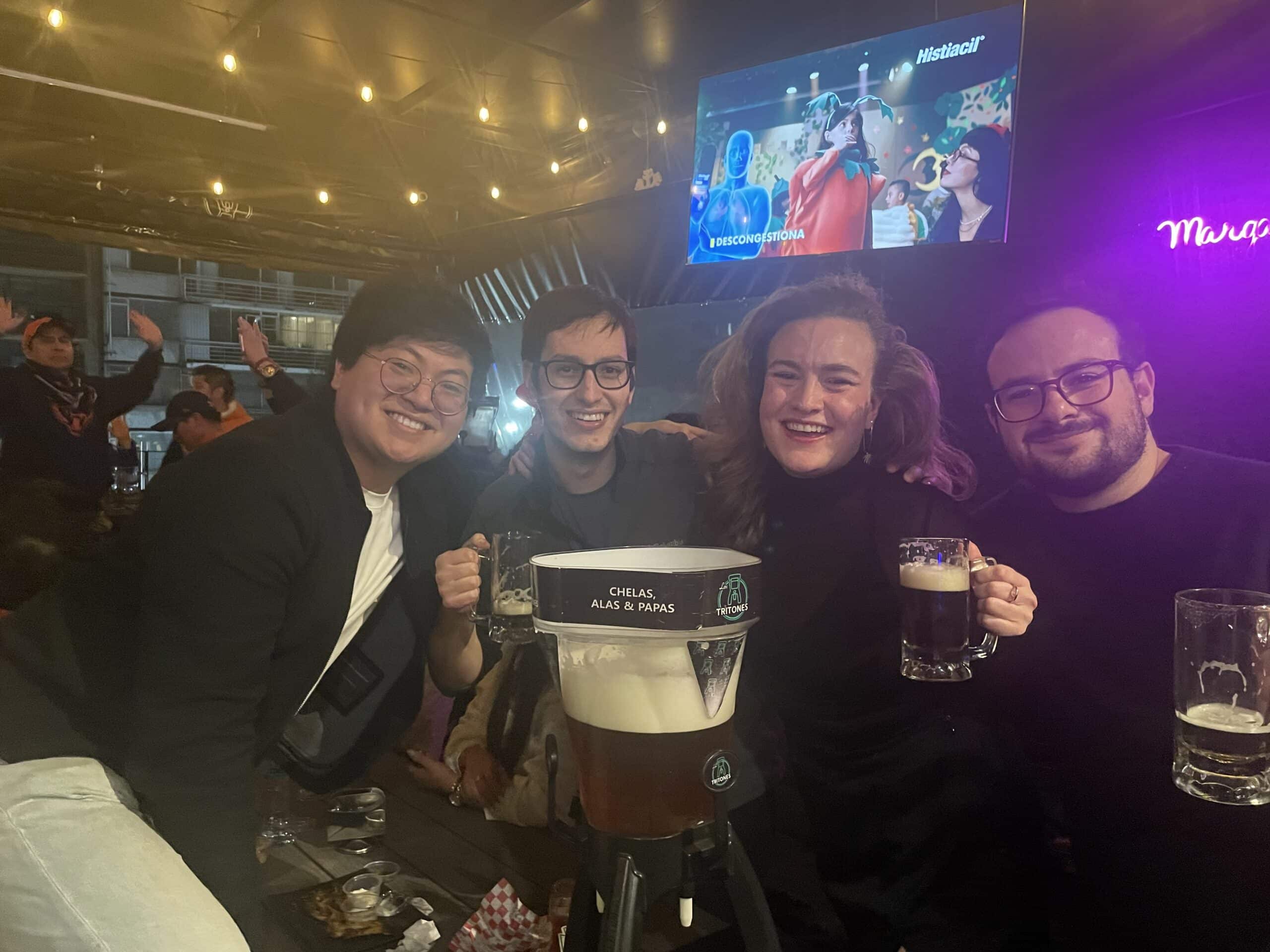 Sam out with friends in a bar.