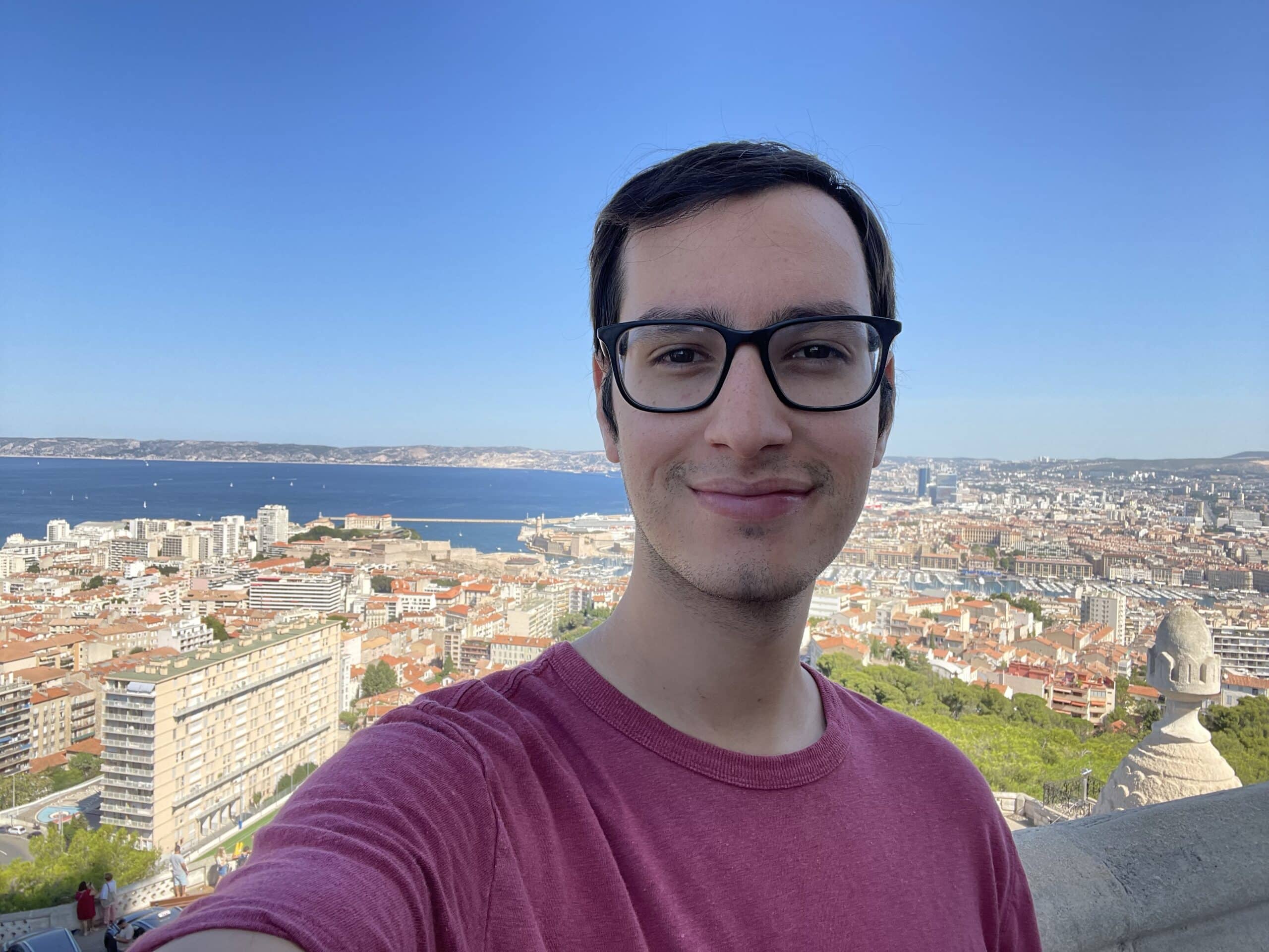 Sam takes a selfie above a city. 